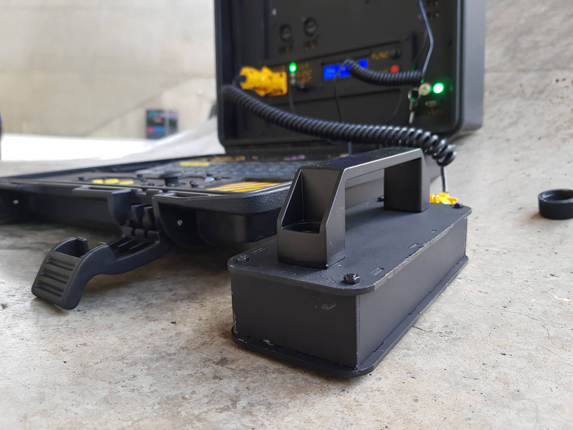 A military-looking cyberdeck with a built-in Geiger counter