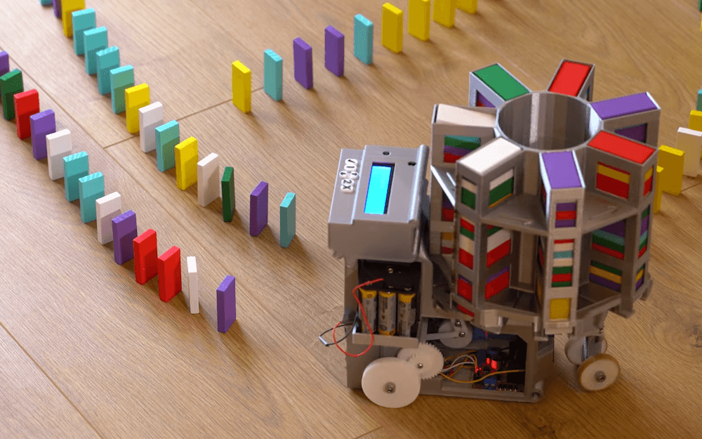 This machine stacks dominoes automatically
