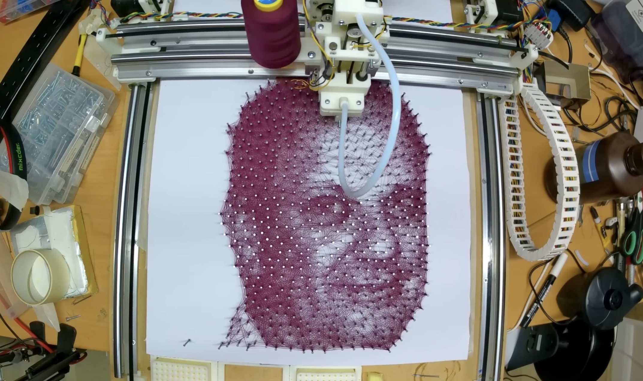 This machine automatically threads beautiful string art
